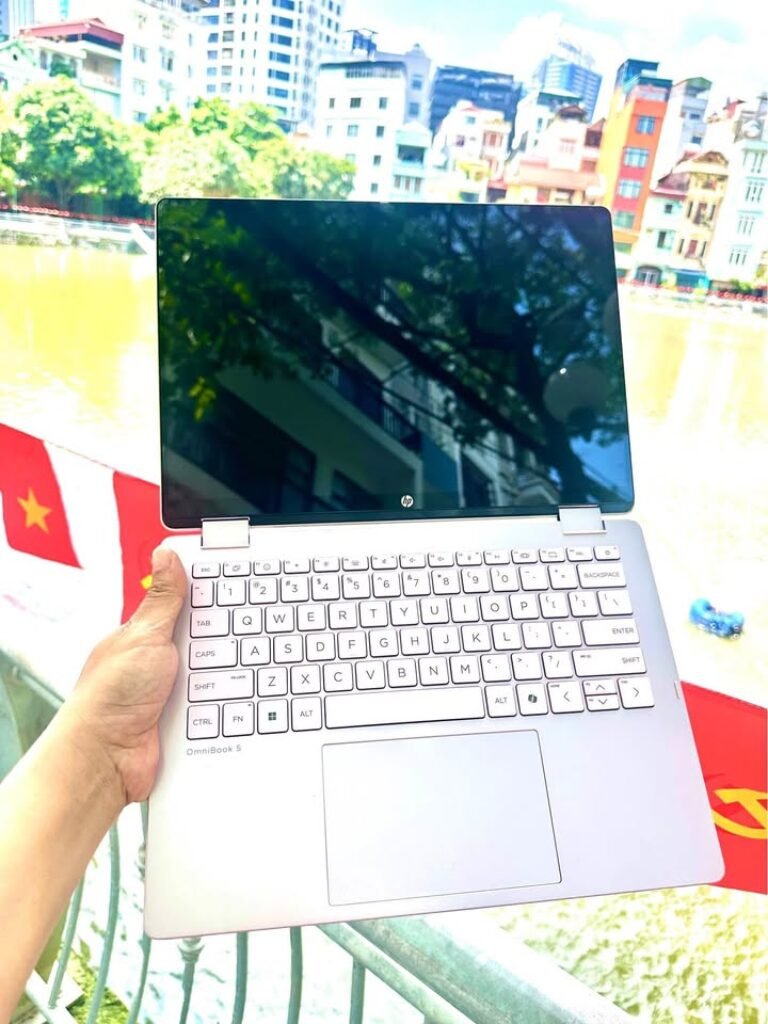 Hand holding Testing HP OmniBook 5 OLED