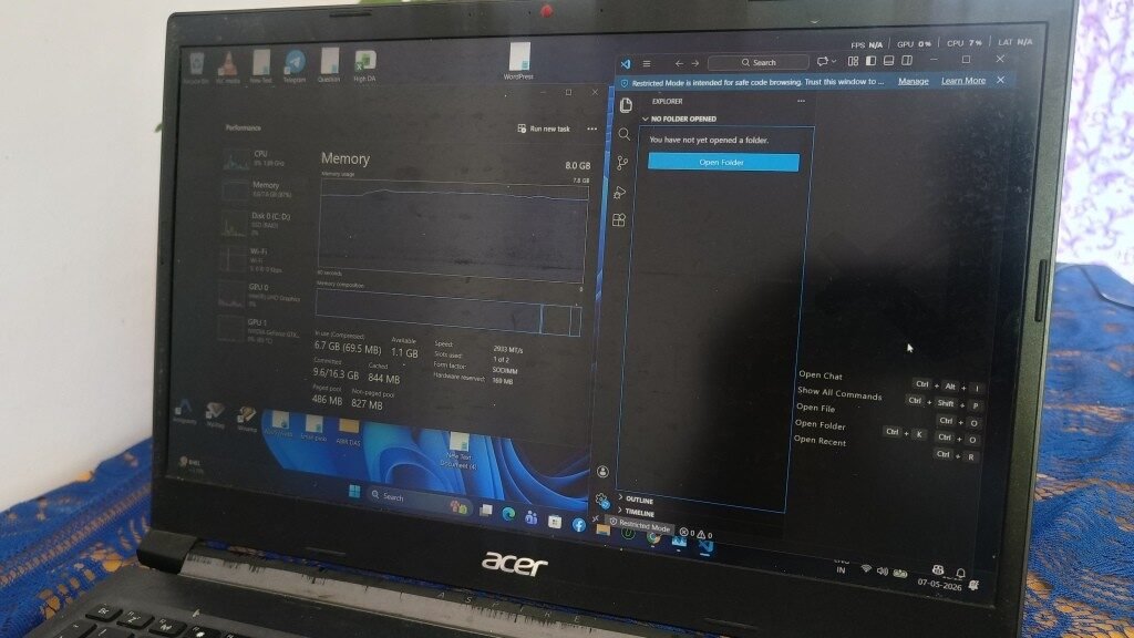 A laptop screen showing Windows Task Manager open next to Visual Studio Code. The Task Manager Memory tab displays a graph with a sharp increase in memory usage, indicating 6.7 GB of 8.0 GB RAM is currently in use just from opening the code editor.