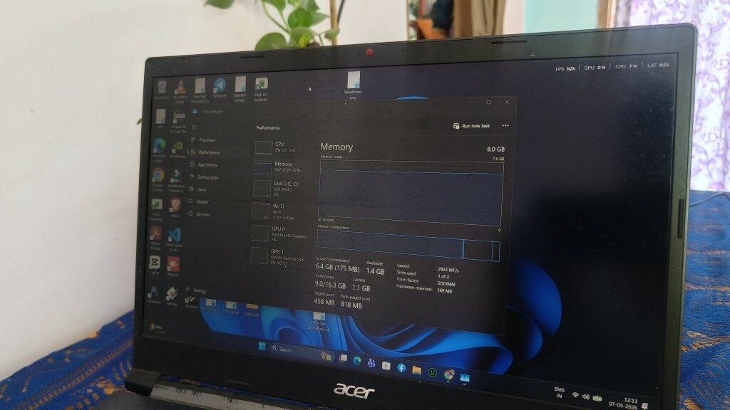A close-up photograph of an Acer laptop screen displaying the Windows 11 Task Manager. The Memory performance tab indicates 8.0 GB of total RAM, with 6.4 GB (82 percent) currently in use, Google Chrome 10 tab open, and 1.4 GB available, illustrating high memory consumption even without heavy development applications like VS Code running.