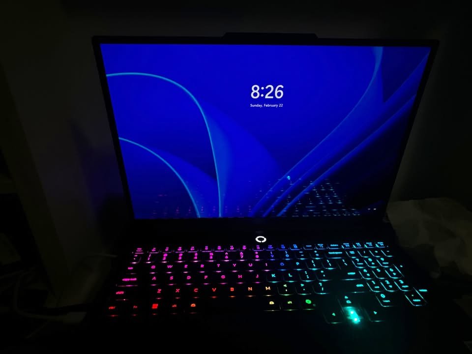 Original low-light performance test of the Lenovo Legion laptop RGB backlit keyboard, demonstrating keycap color visibility and screen reflection during night use.
